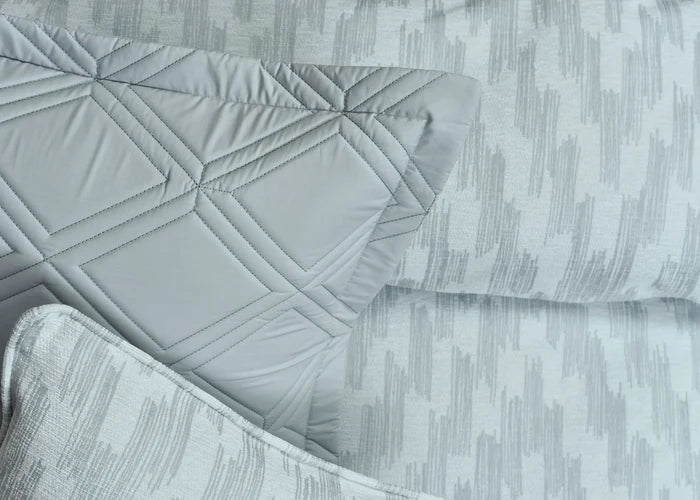 Grey quilted duvet cover with stitched diamond pattern and vertical stripe texture