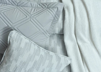 Grey duvet cover corner with quilted stitching and coordinating textured pillowcase