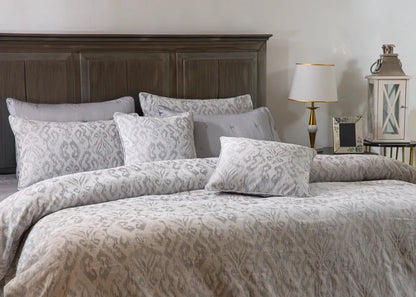 Grey duvet cover set with patterned pillows and square pillow shams, front view