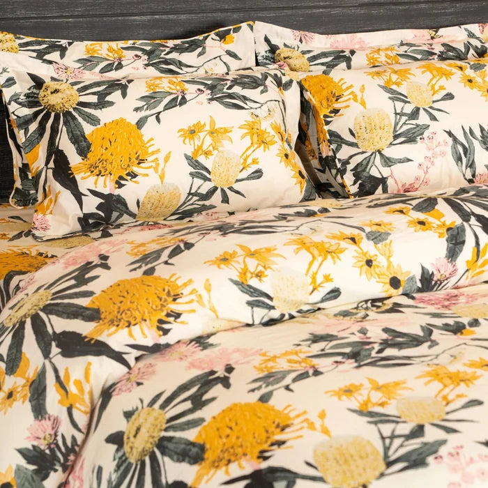 Floral pillowcases and duvet with cream base, yellow blooms and green stems