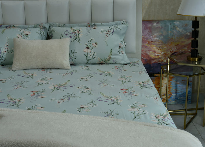 Ice blue cotton sateen bed sheet with scattered floral pattern, neatly laid