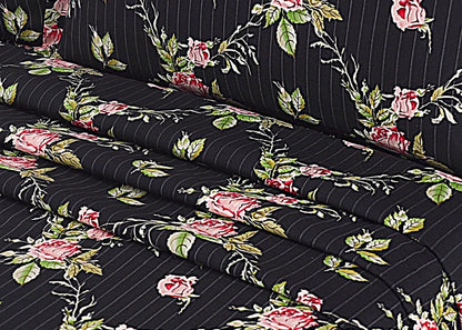 Rolled black floral cotton bed sheet with red roses, green leaves, and vertical stripes