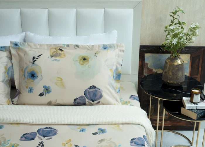 Cream cotton bed sheet featuring blue and yellow flower print with coordinating textured border