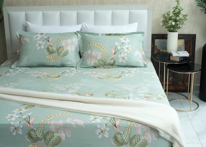 Light green tropical floral bed sheet with leaf and flower print, neatly draped
