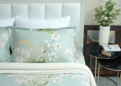 Light green tropical floral bed sheet and pillowcases with leaf and blossom print
