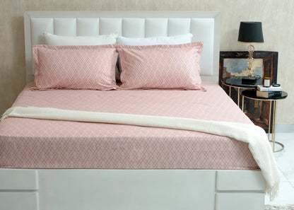 Pink diamond-pattern bed sheet set with matching pillowcases and shams