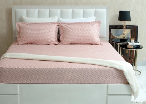 Pink diamond-pattern bed sheet set with matching pillowcases and shams