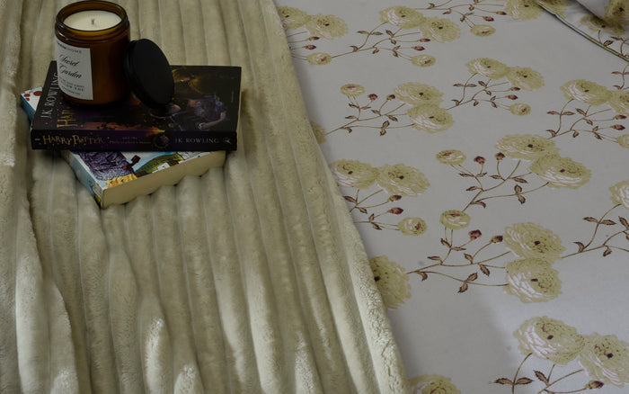 Floral micro fiber bed sheet corner with beige striped fabric fold