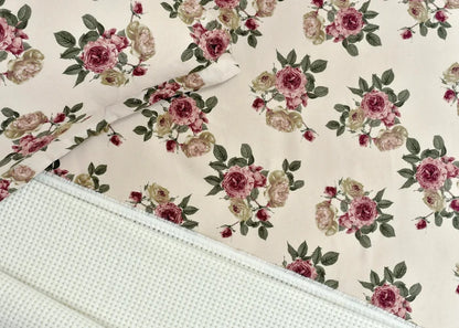 Cream microfiber bed sheet fabric with pink rose floral pattern and stitched edge