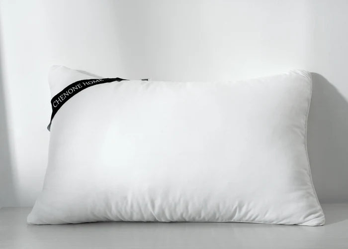White rectangular compressed pillow with corner seam and side fabric tag
