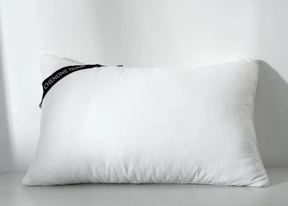 White rectangular compressed pillow with corner seam and side fabric tag