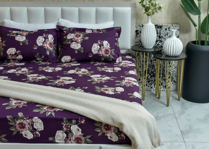 Purple floral pillow cover with white and pink rose print, decorative trim