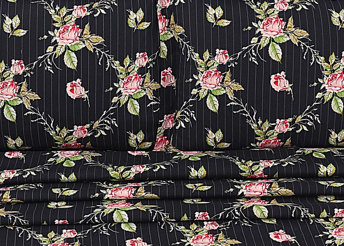 Black cotton pillow cover with vertical pinstripes and rose floral pattern, folded view