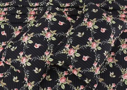 Black cotton pillow cover fabric close-up with dense floral vine diamond pattern