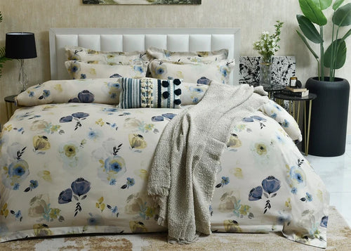 Cotton quilt cover in pale tones with blue and yellow floral print and textured throw