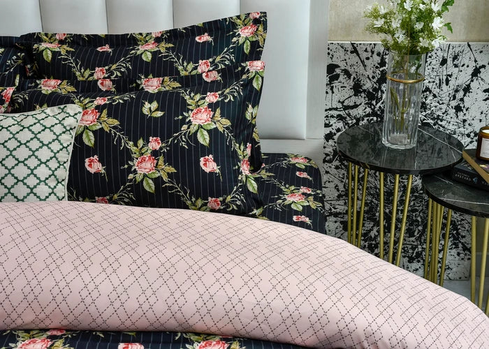 Black quilt cover with pink rose floral pattern and mauve geometric grid panel