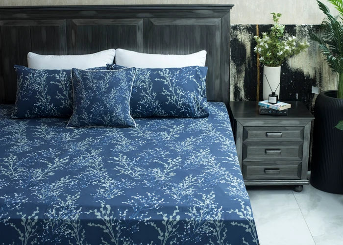 Navy cotton bed sheet on bed with white tree branch pattern