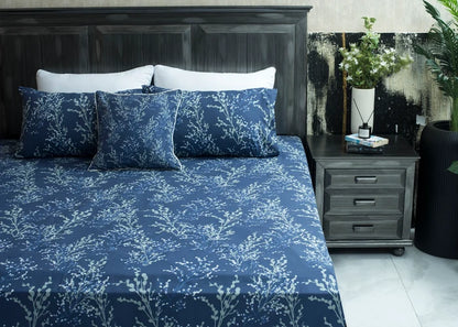 Navy cotton bed sheet on bed with white tree branch pattern