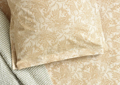 Beige cotton bed sheet with close-up ornate damask pattern and stitched hem detail