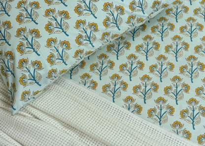 Cotton bed sheet with blue and yellow floral tree pattern