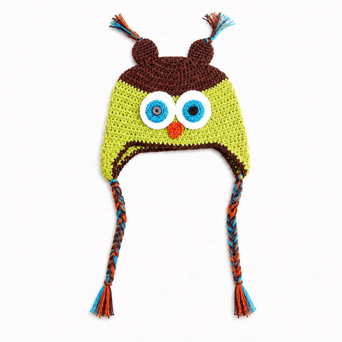 Crocheted owl hat with large embroidered eyes, a small orange beak, brown ear covers, and braided ear ties in blue, orange, and brown on a white background.