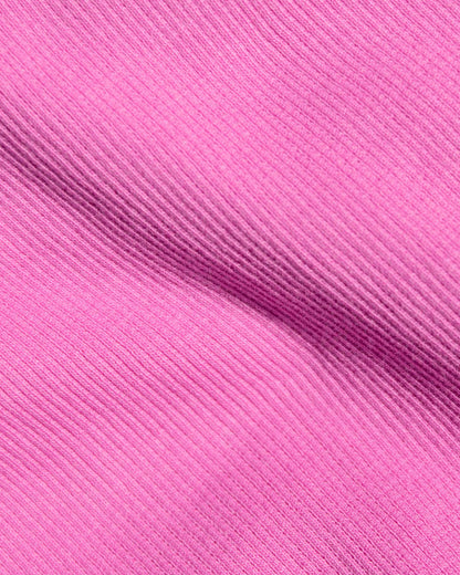 A close-up of bright pink ribbed fabric.