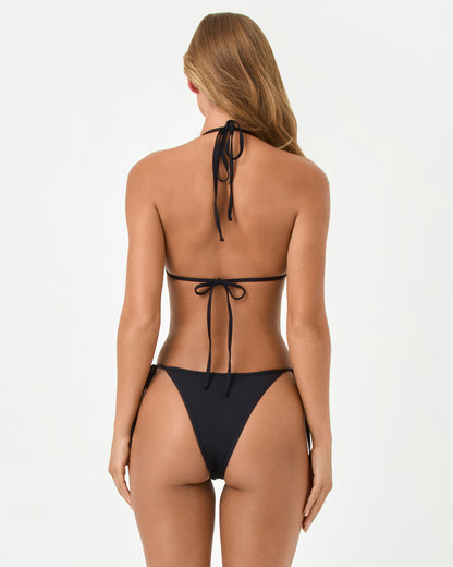 Back view of a model wearing the LSPACE black Aspen Bikini Top and Levy Bikini Bottom showing the cheeky cut and side ties.