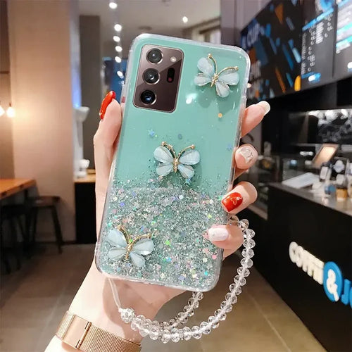 a woman holding a phone case with a green glitter phone cover