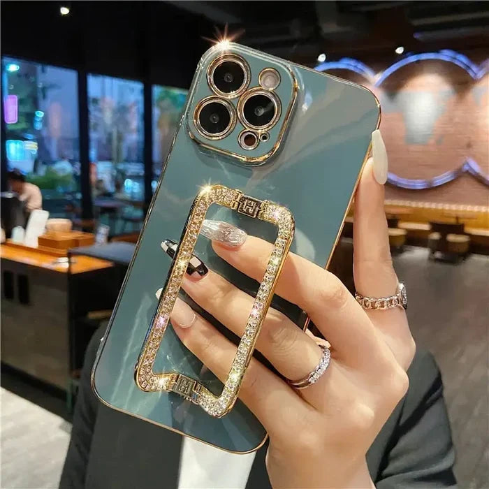 a woman holding a phone case with a ring on it