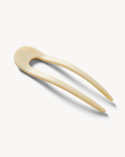 Angled view of the white Machete French Hair Pin showing the resin finish.