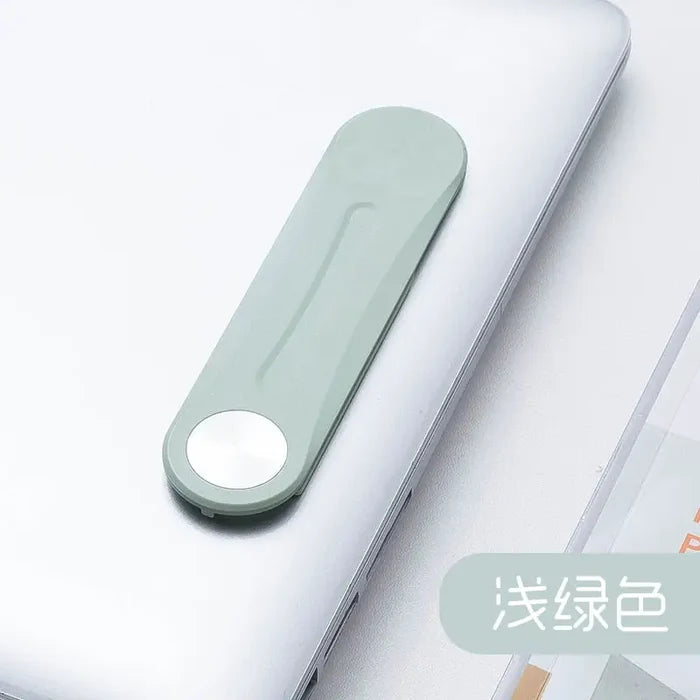 a laptop with a white keyboard and a green mouse