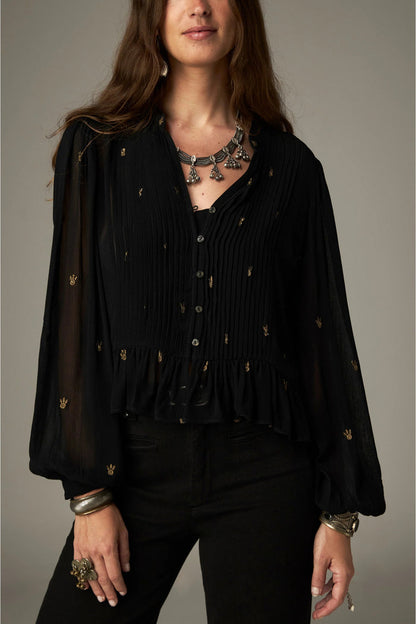 Shop the Maison Hotel Catherine Blouse in Blackout at Dotique. An embroidered black blouse with a cropped shape, ruffled hem and mother-of-pearl buttons.