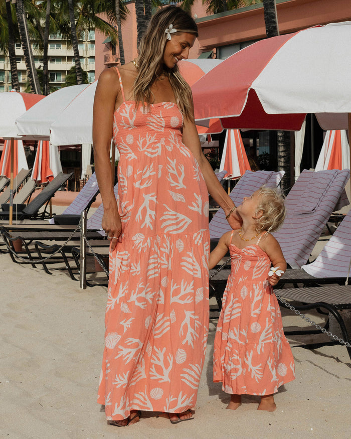 LSPACE Menorca dress in Shell Or High Water print, lifestyle/editorial view on model at a beach resort.