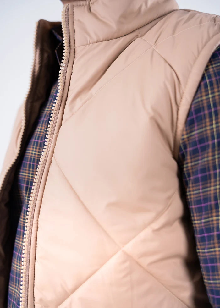 Beige quilted bubble jacket close-up, full-zip front and stitched panel seams