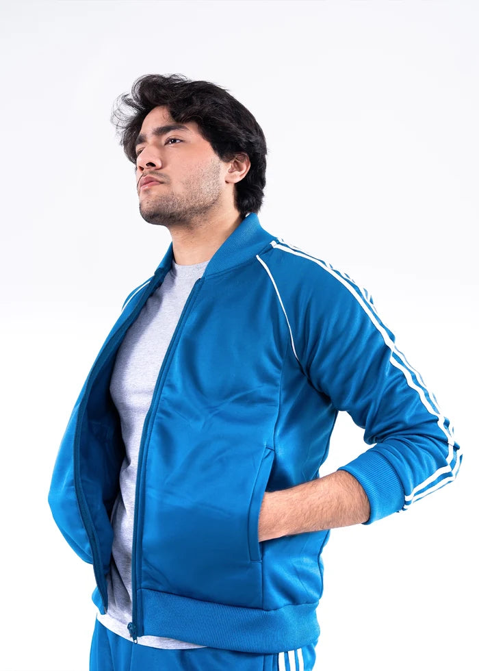 Men's blue zip-up hooded jacket with white side stripes over gray crew neck sweatshirt