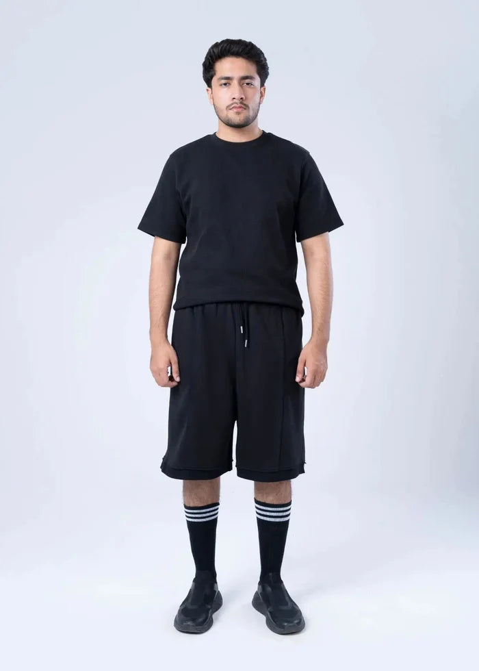 Black terry-knit knee-length shorts with drawstring and elastic waist