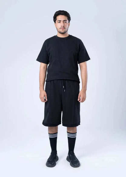 Black terry-knit knee-length shorts with drawstring and elastic waist