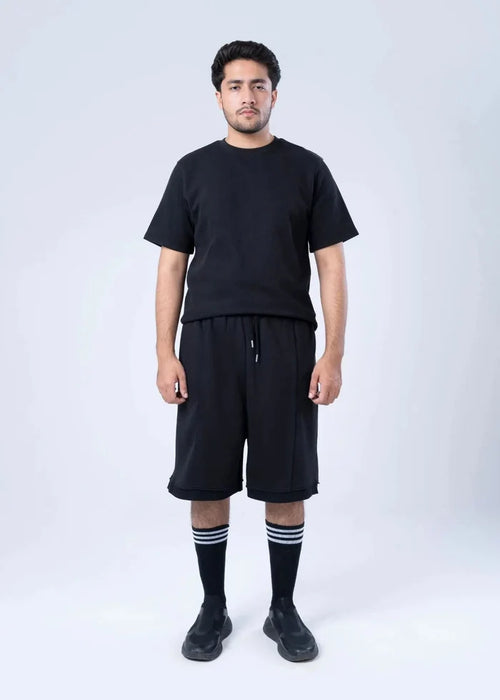Black terry-knit knee-length shorts with drawstring and elastic waist