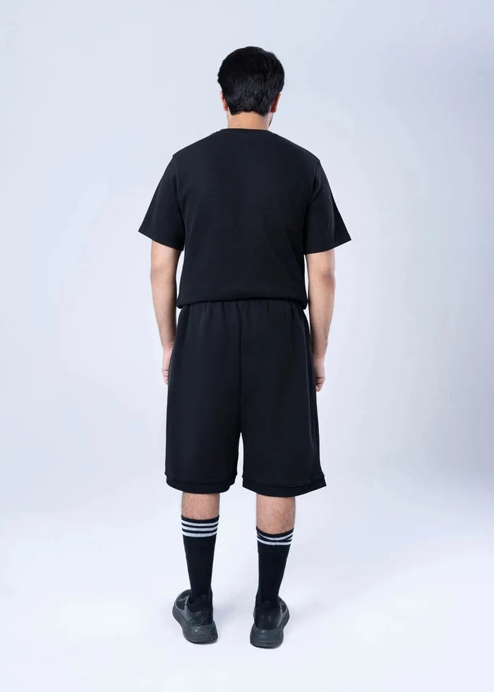 Black terry-knit drawstring shorts with elastic waistband, knee-length