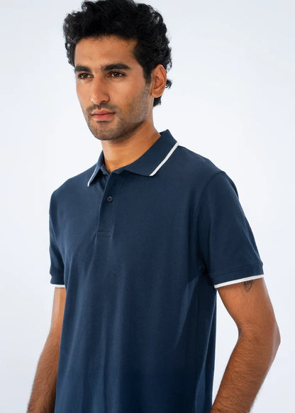 Navy polo shirt with white-trim collar, short sleeves, and button placket