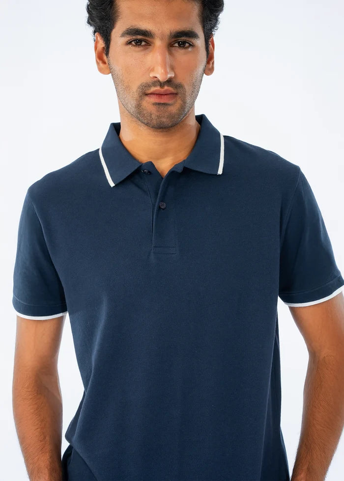 Men's navy cotton pique polo shirt with white-trim collar and 3-button placket