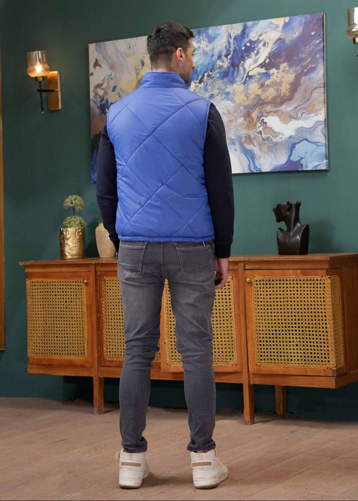 Men's blue quilted puffer jacket back view, full length zipper