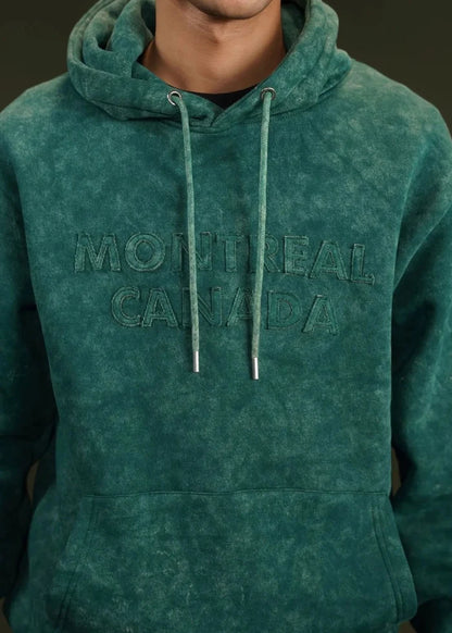 Teal terry hoodie close-up with 'MONTREAL CANADA' front print and drawstrings