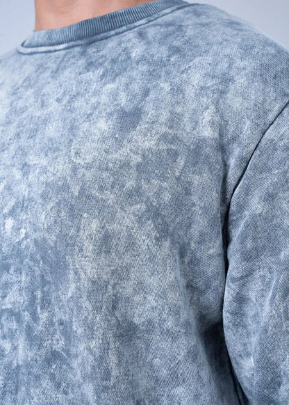 Grey terry sweatshirt fabric close-up, crew neck seam detail at shoulder.