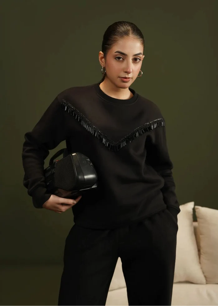 Black crewneck fleece sweatshirt with V-shaped fringe trim and long sleeves