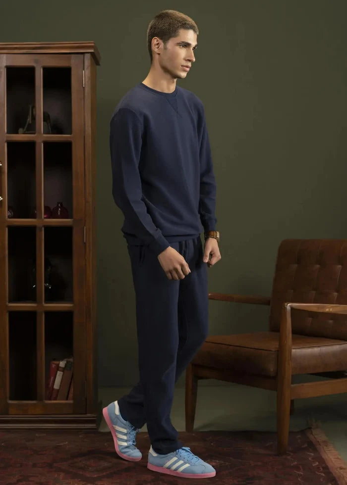 Navy crewneck sweatshirt, long sleeves and ribbed hem, worn with matching joggers