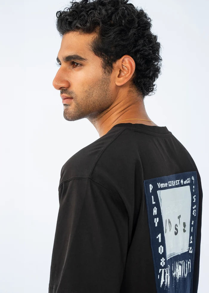 Black crew-neck cotton jersey T-shirt with large back typography graphic, side view