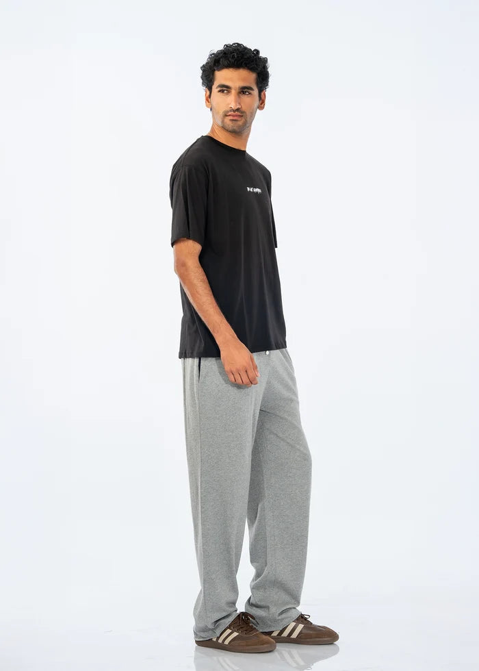 Black crew-neck T-shirt with small chest logo, side view