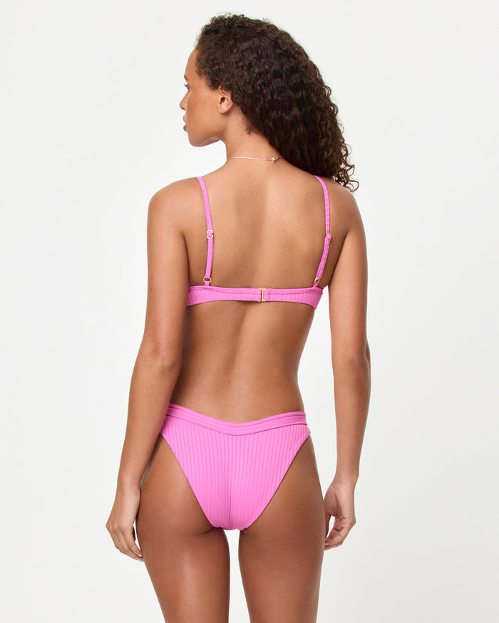Back view of a model wearing the LSPACE Sweetheart Mercer Bikini Bottom with ribbed fabric.