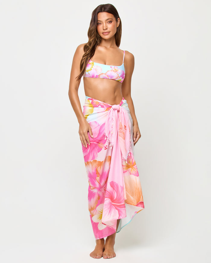 LSPACE Mika Sarong in Hibiscus And Plumeria Oh My print, front view on model tied as maxi wrap.